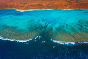 Vue aérienne sur Ningaloo avec les nuances de couleurs entre l'outback, la plage et les eaux